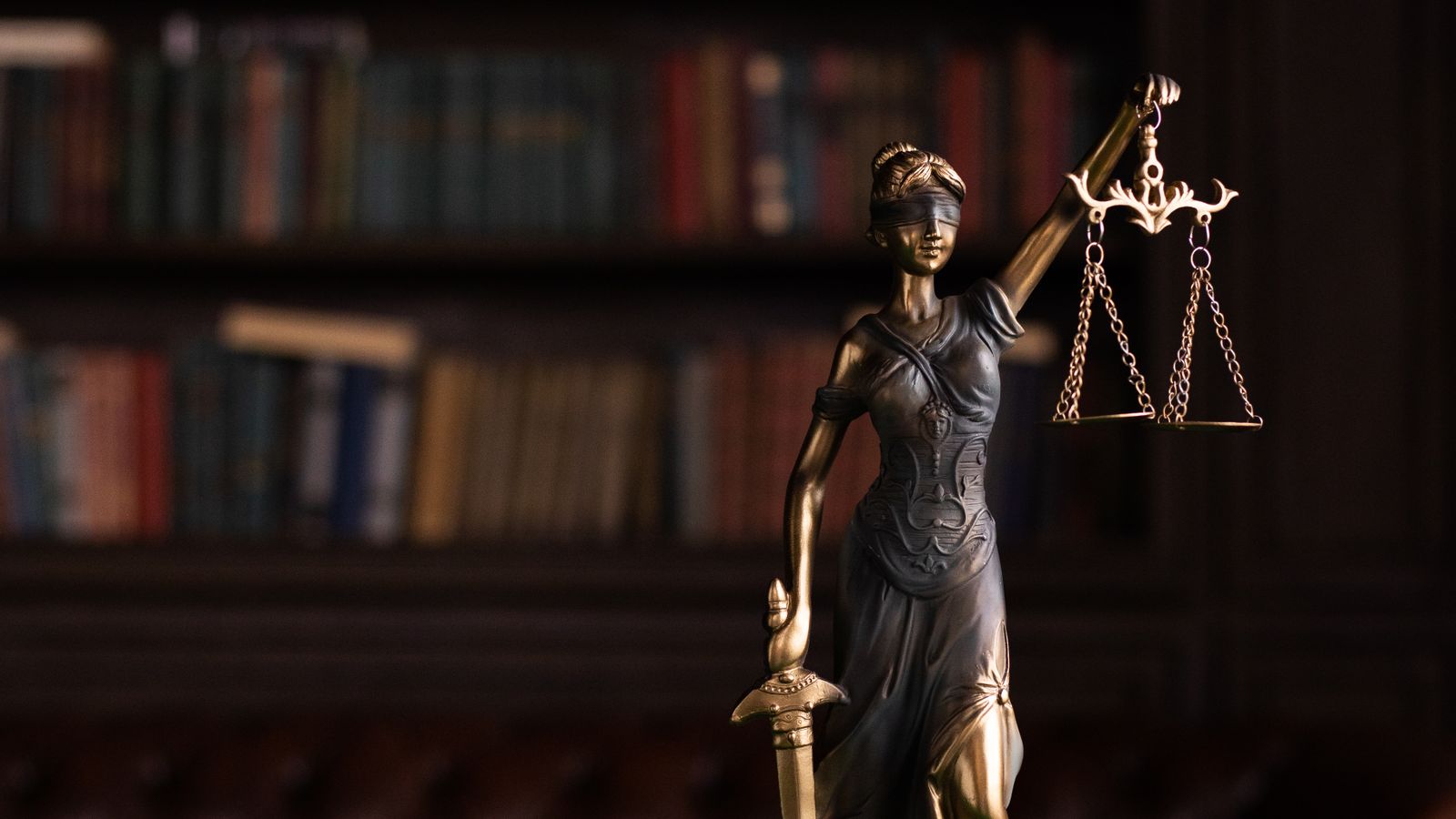 Lady Justice statue with scales and gavel symbolizing legal representation